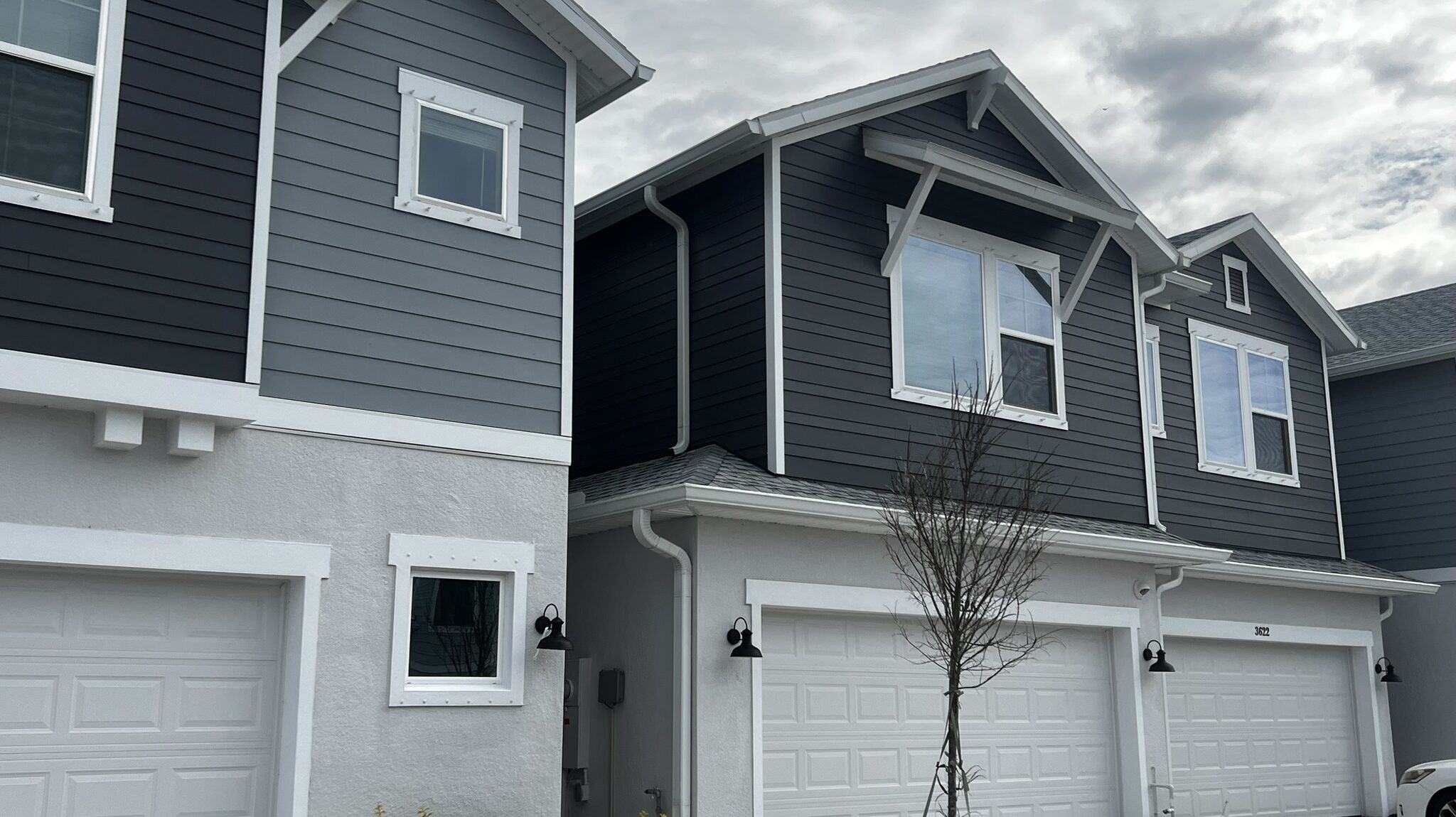 Row of Florida townhomes with finished white seamless gutters and downspouts