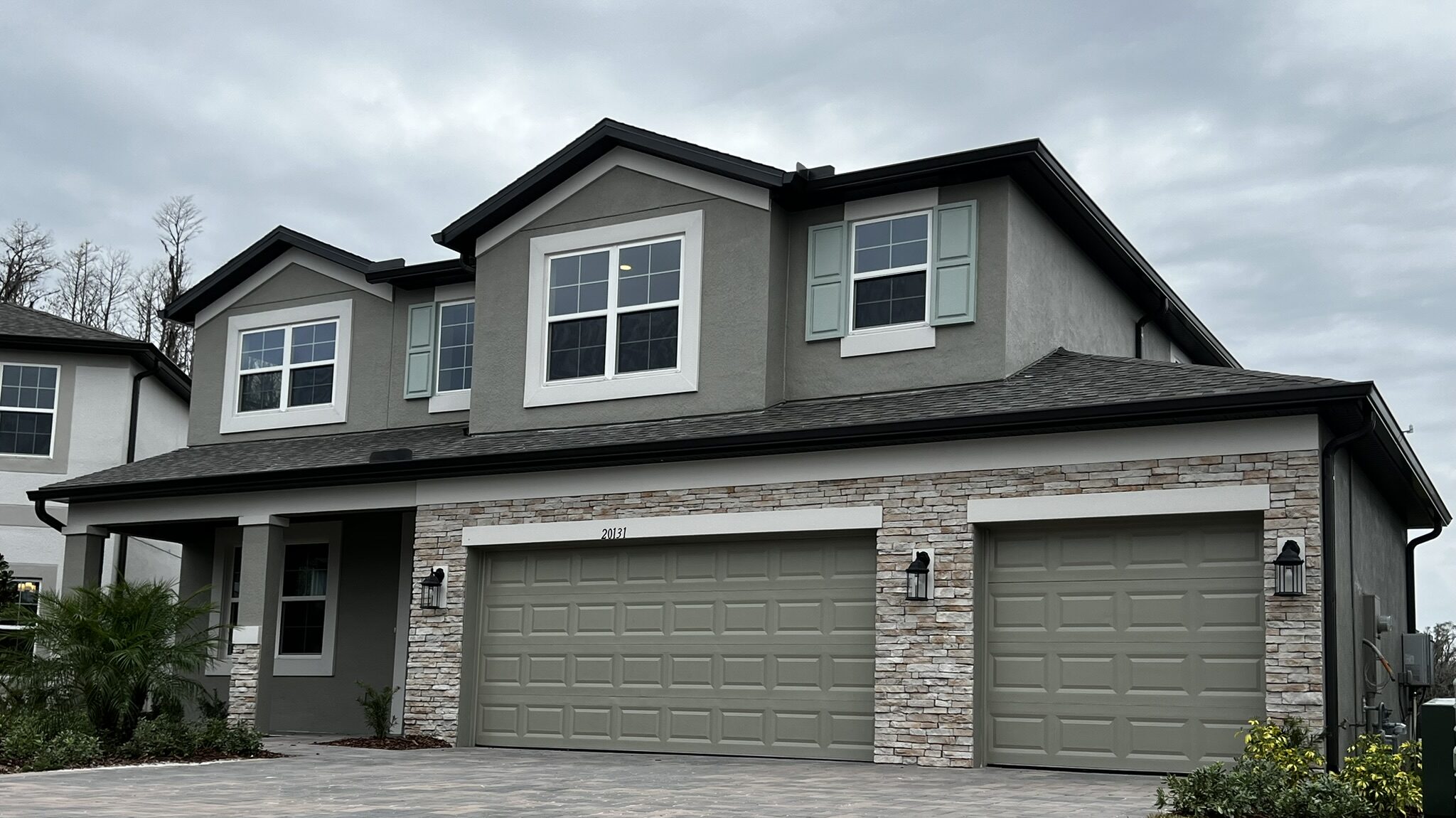 Two-story Florida home with white seamless gutters along the roofline